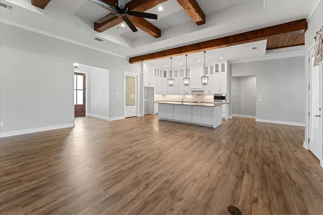 a kitchen with kitchen island white cabinets and refrigerator