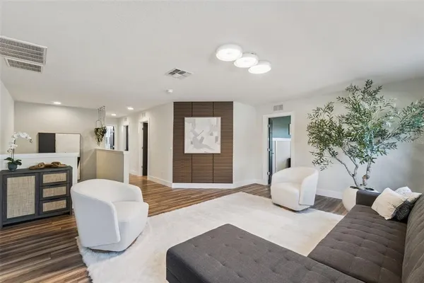 a living room with furniture and a large mirror