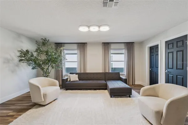 a living room with furniture and a large window