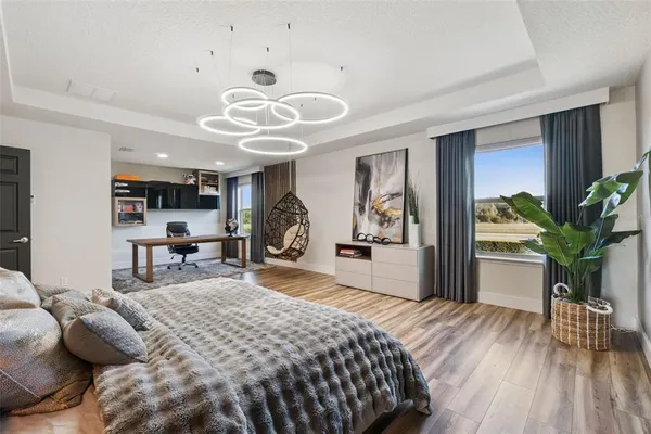 a bedroom with a bed and a large window