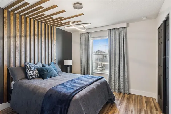 a bedroom with a bed and a mirror