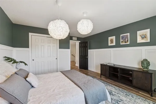 a bedroom with a bed and a chandelier