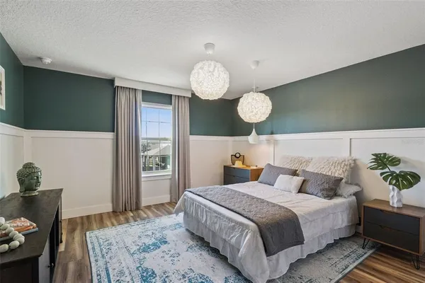 a bedroom with bed and wooden floor