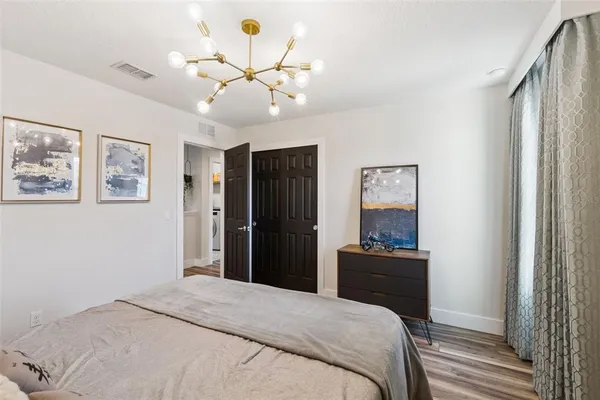 a bedroom with a bed and a chandelier