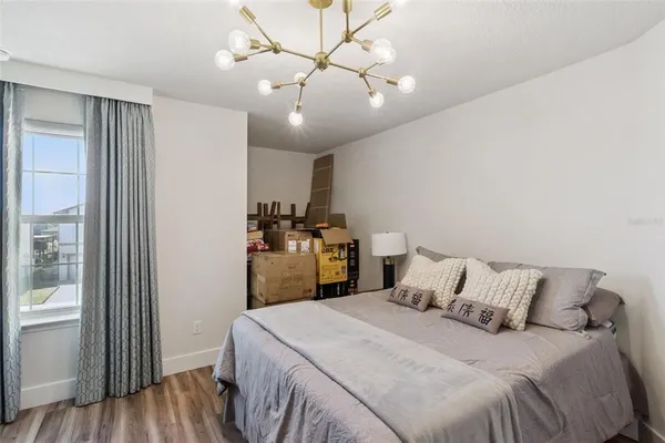 a bedroom with a bed and a chandelier