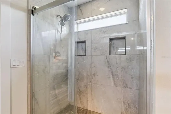a bathroom with a glass shower door