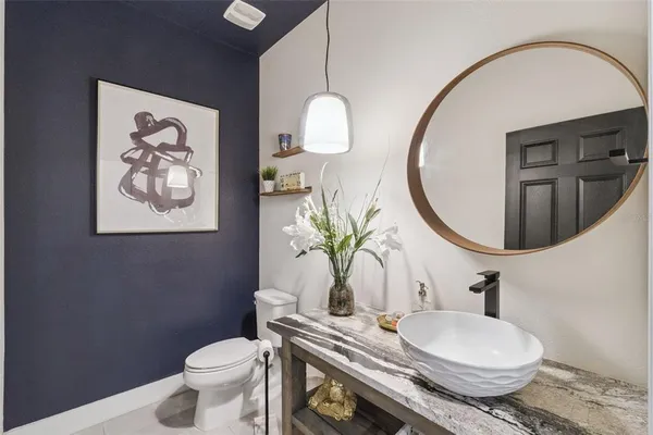 a bathroom with a toilet a sink and mirror