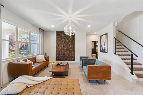 a living room with furniture and a chandelier