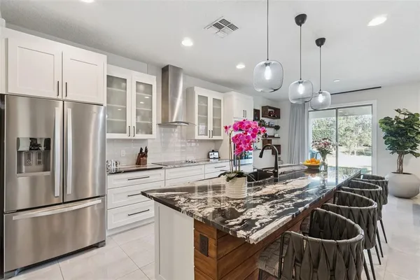a kitchen with stainless steel appliances granite countertop a stove refrigerator and microwave