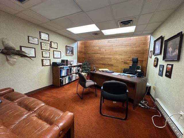301 Chestnut Street Virginia, MN 55792 - Photo 13 of 31 Home office featuring a baseboard heating unit, a drop ceiling, a textured wall, and wood walls