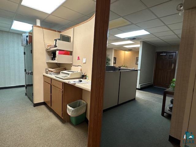 301 Chestnut Street Virginia, MN 55792 - Photo 7 of 31 Kitchen with brown cabinets, a paneled ceiling, light countertops, and open shelves