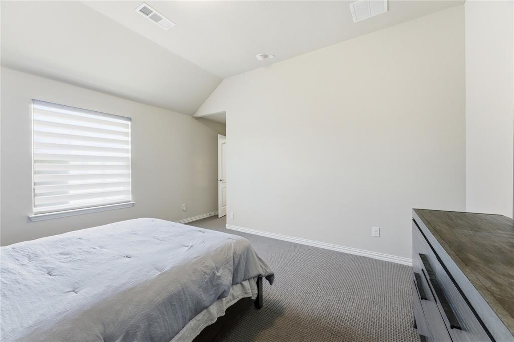 7705 Falcon Ridge Road Denton, TX 76208 - Photo 31 of 40 Bedroom featuring dark carpet and lofted ceiling