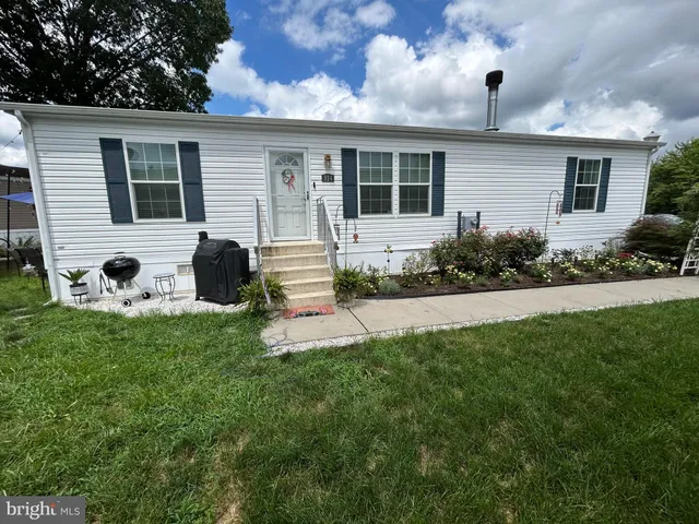 a view of house with backyard outdoor seating and garden