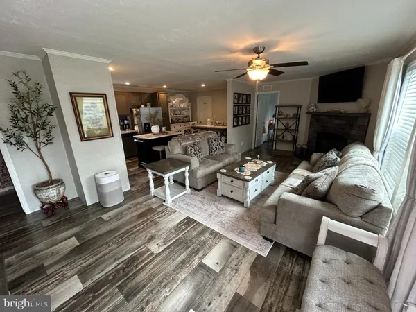 a living room with lots of furniture and a chandelier