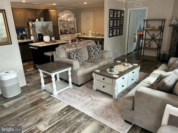 a living room with furniture a rug and white walls