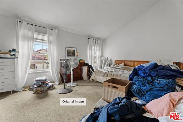 a living room with furniture a window and gym cycle
