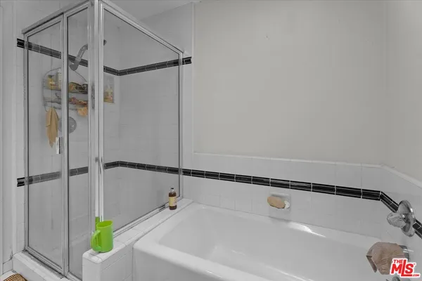 a bathroom with a bathtub and a shower