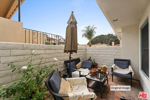 a backyard of a house with outdoor seating