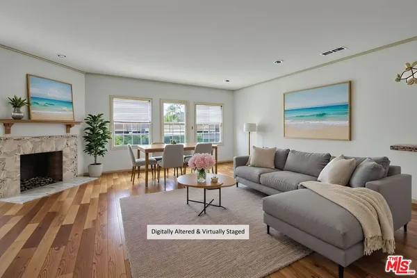 a living room with furniture a large window and a fireplace