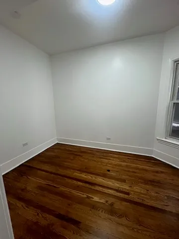 a view of room with wooden floor and window