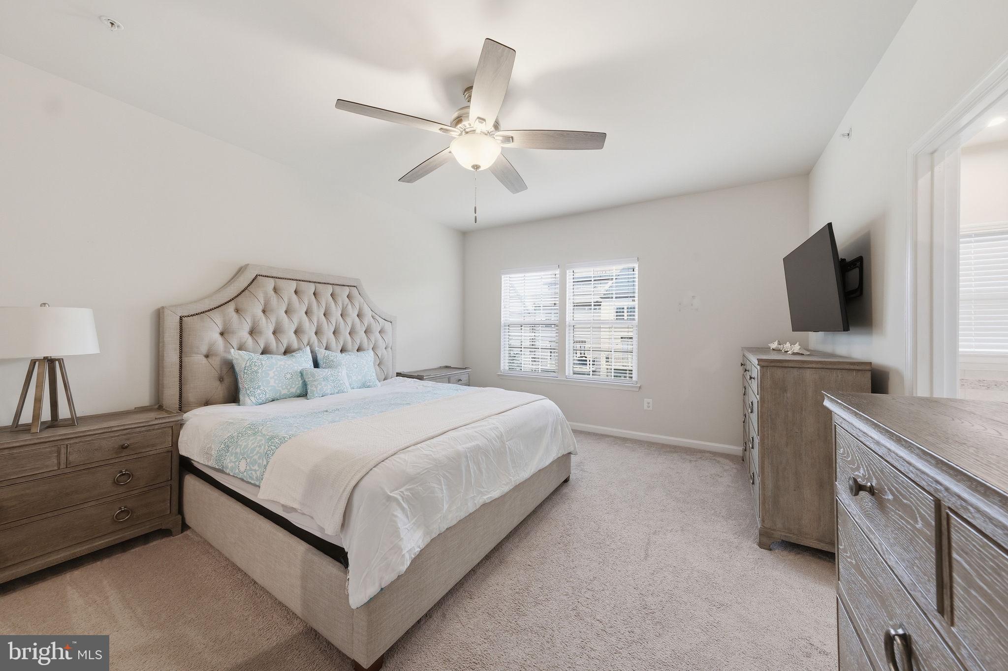 3012 Bretons Ridge Way Hanover, MD 21076 - Photo 16 of 37 a bedroom with a bed and a flat screen tv