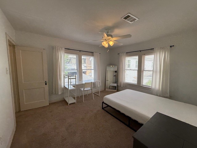 1710 Bolsover Street, Unit 2 Houston, TX 77005 - Photo 15 of 22 a spacious bedroom with a bed and a chandelier