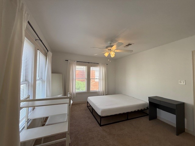 1710 Bolsover Street, Unit 2 Houston, TX 77005 - Photo 16 of 22 a spacious bedroom with a bed and a chandelier