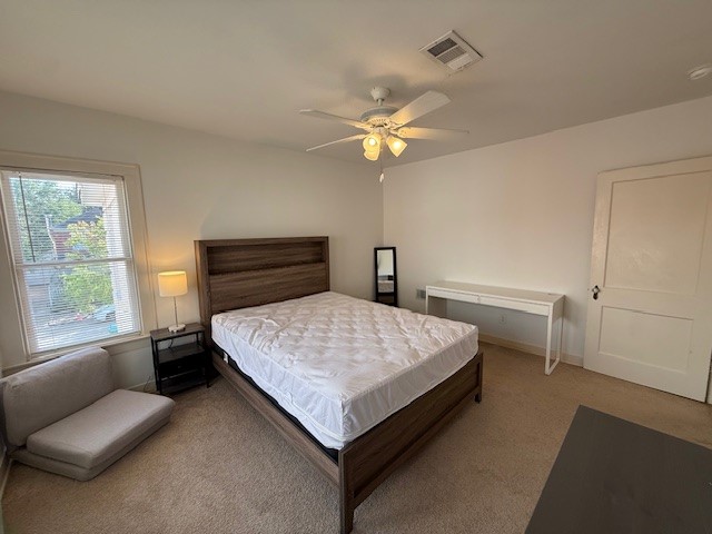 1710 Bolsover Street, Unit 2 Houston, TX 77005 - Photo 18 of 22 a bedroom with a bed and a chandelier