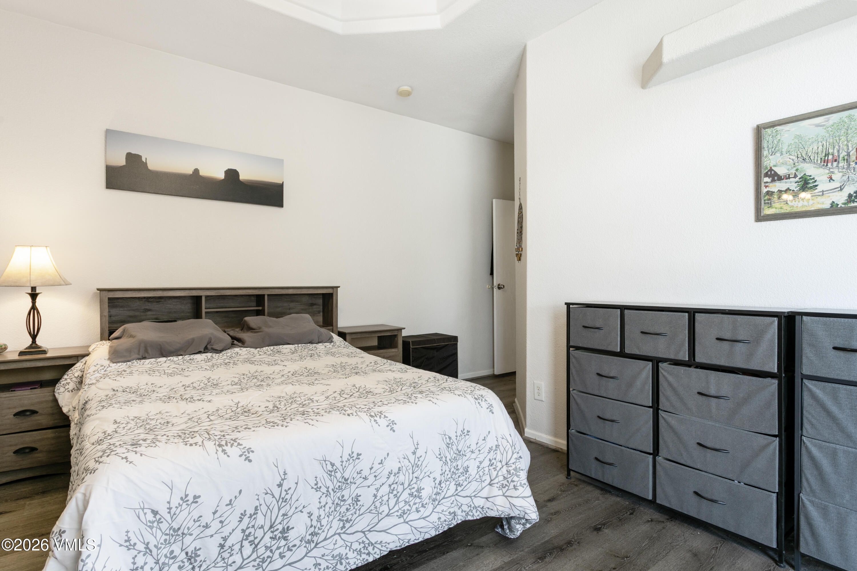 161 Haymaker Loop Gypsum, CO 81637 - Photo 16 of 40 a bedroom with a bed and a night stand