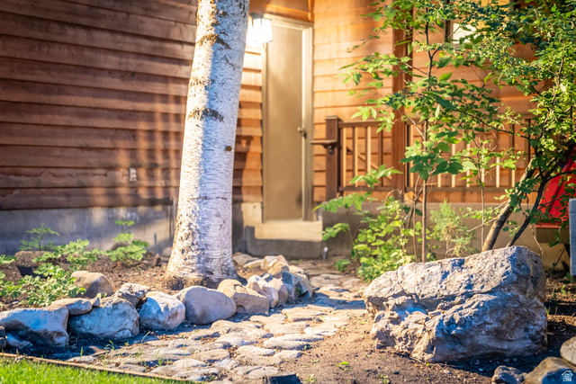 435 Canyon Road Millville, UT 84326 - Photo 101 of 113 Cobblestone pathway leading to an entry door on a wood-sided structure