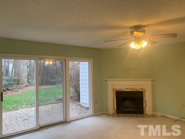7743 Falcon Rest Circle Raleigh, NC 27615 - Photo 2 of 11 Spacious family room with cozy wood burning fireplace.