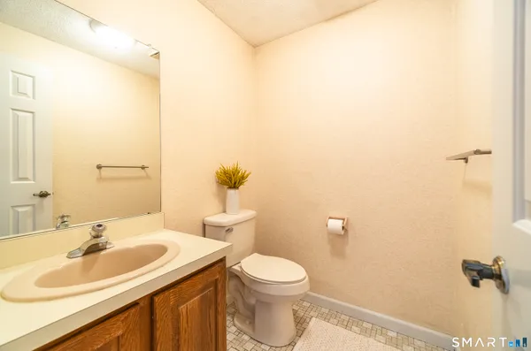 a bathroom with a sink a toilet and a mirror