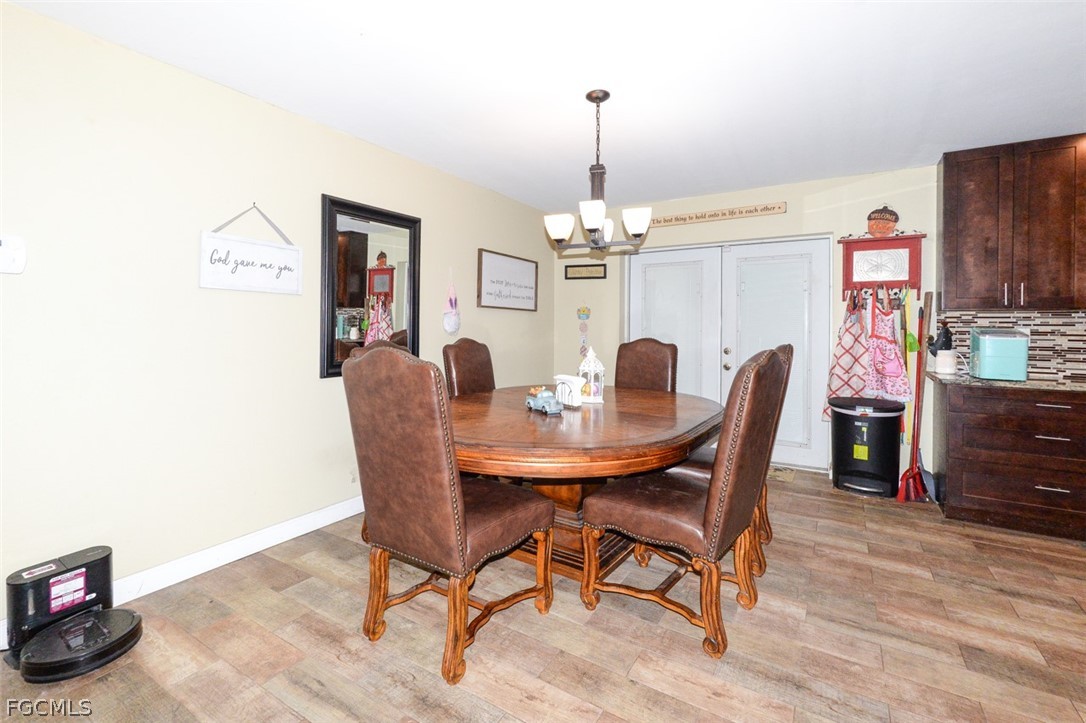 15581 Old Olga Road Alva, FL 33920 - Photo 12 of 38 a view of a dining room with furniture and wooden floor