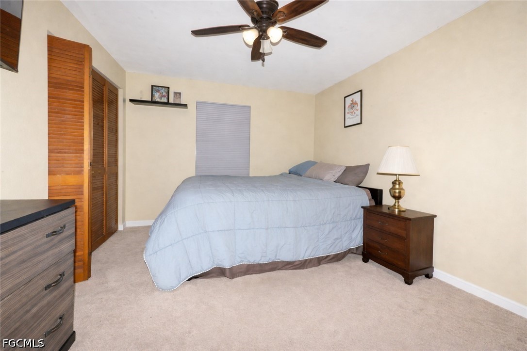 15581 Old Olga Road Alva, FL 33920 - Photo 16 of 38 a bedroom with a bed and ceiling fan
