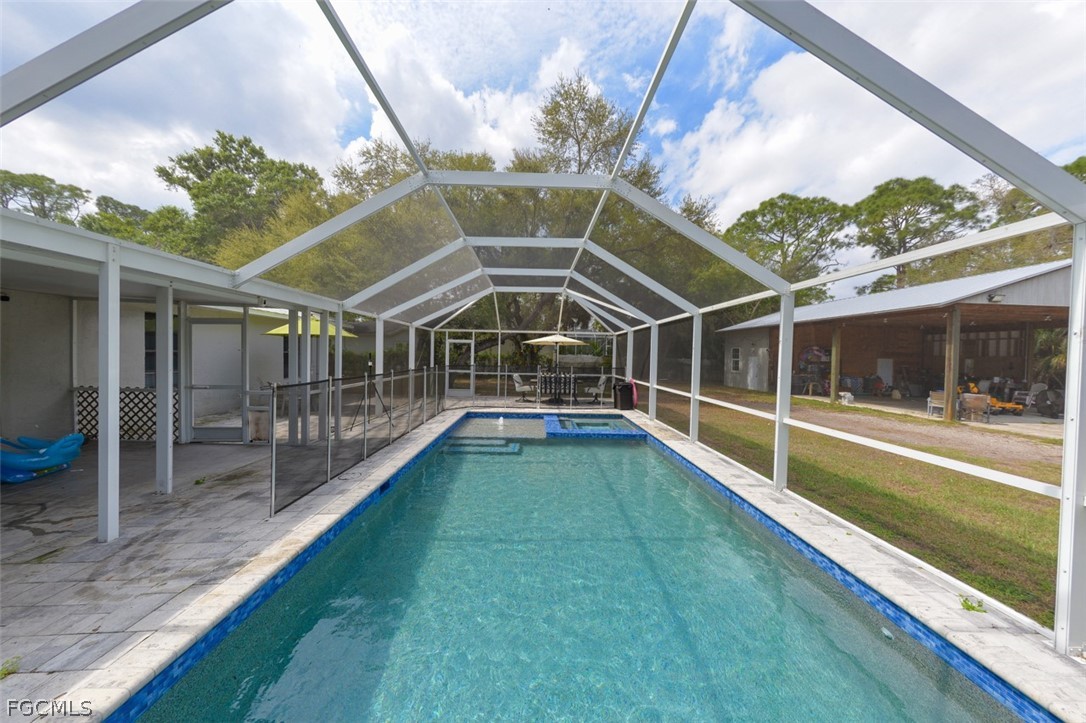 15581 Old Olga Road Alva, FL 33920 - Photo 19 of 38 a view of a house with swimming pool
