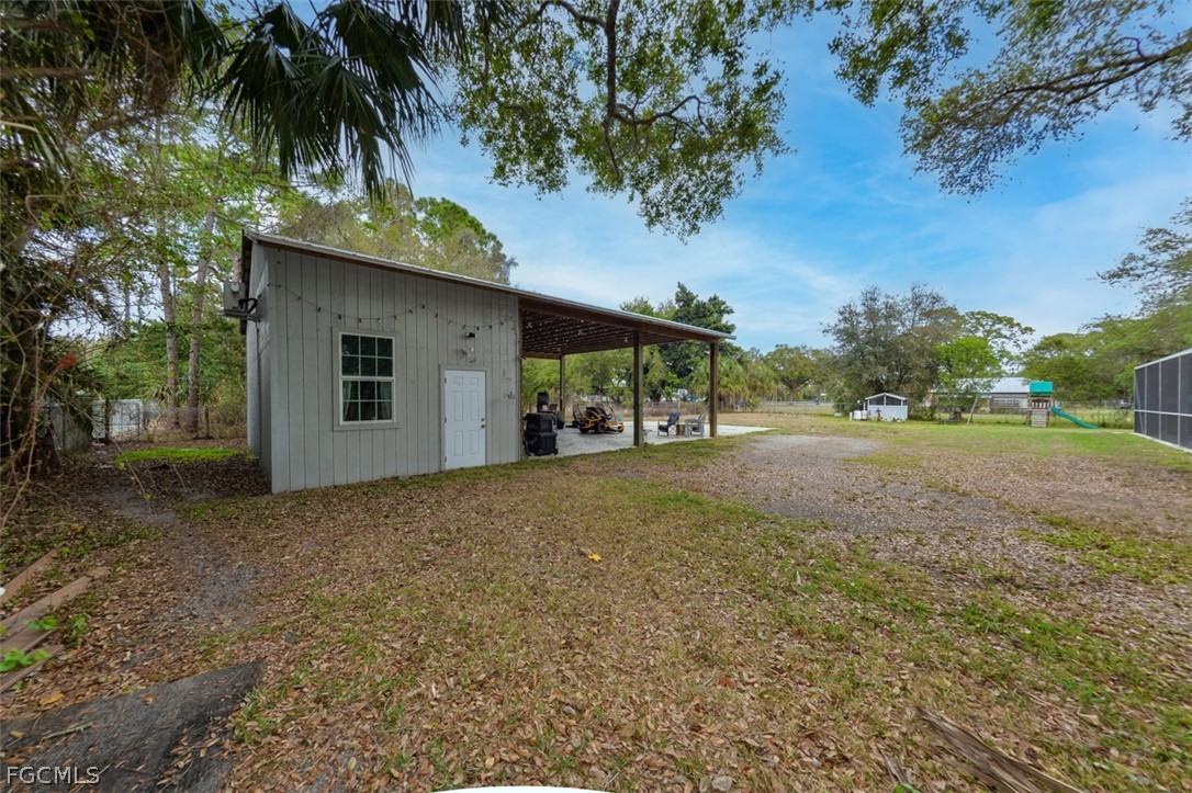 15581 Old Olga Road Alva, FL 33920 - Photo 25 of 38 a backyard of a house with table and chairs