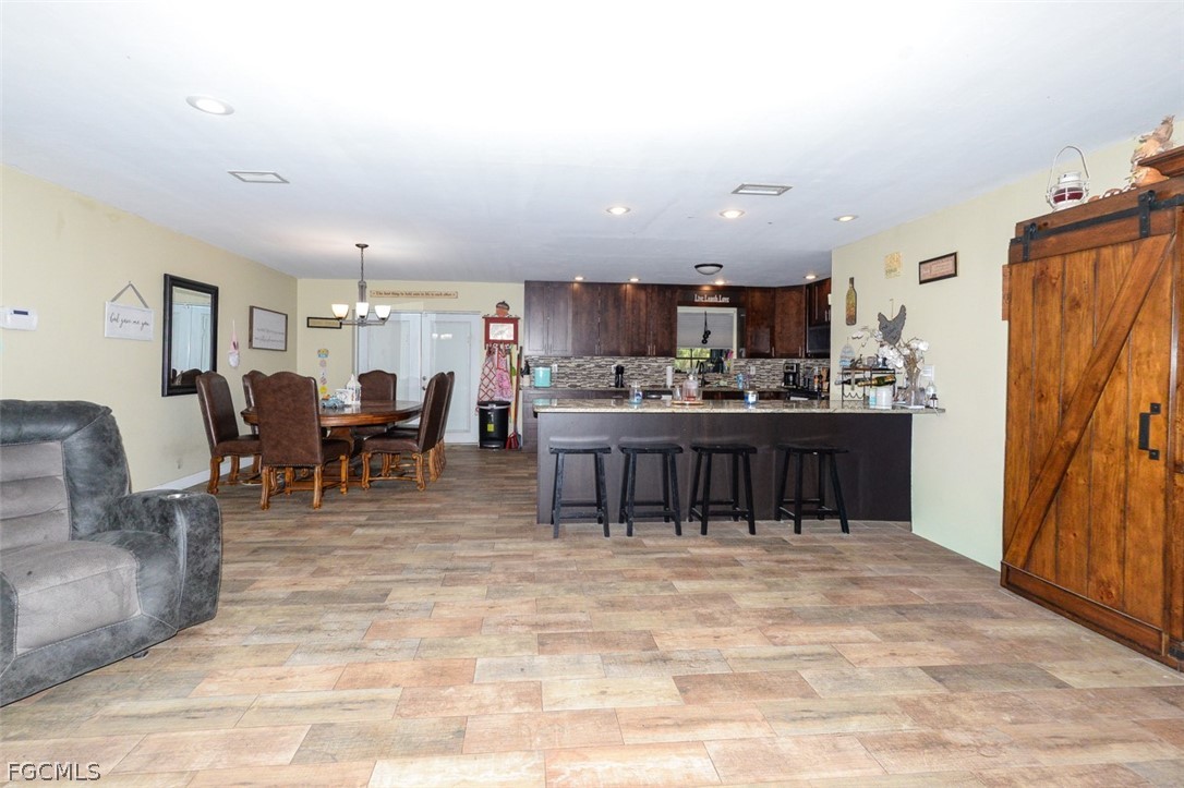 15581 Old Olga Road Alva, FL 33920 - Photo 10 of 38 a living room with stainless steel appliances furniture a kitchen view and a kitchen island