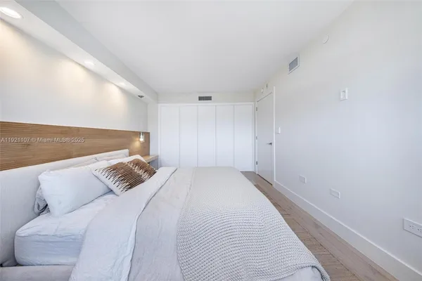 a bedroom with a bed and a couch