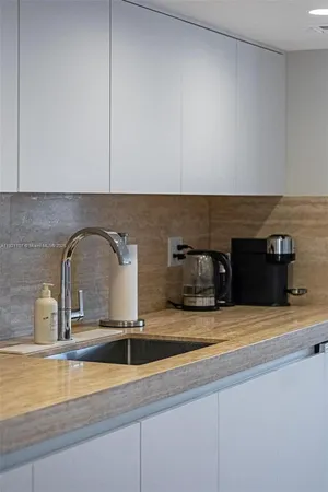 a kitchen with a sink and a stove top oven