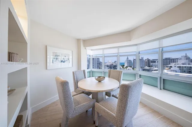 a dining room with furniture a window and a kitchen