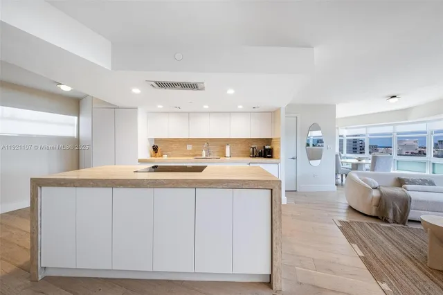 a large white kitchen with a large window