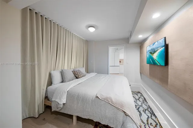 a bedroom with a bed and a flat screen tv