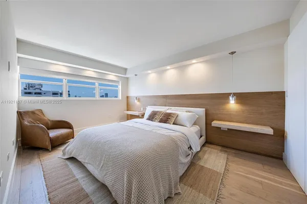 a bedroom with bed and window