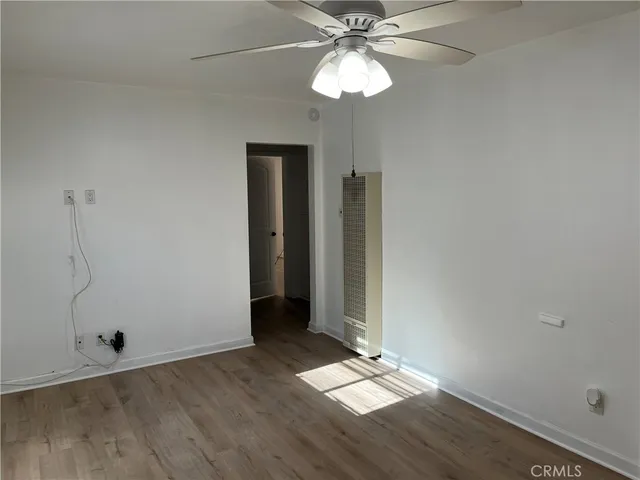a view of a livingroom with furniture and chandelier fan