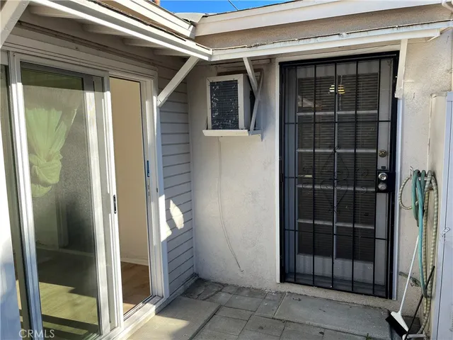 a view of a patio with table and chairs potted plants