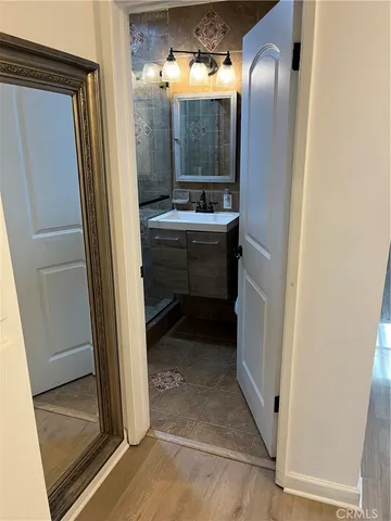 a view of a room with wooden floor and furniture