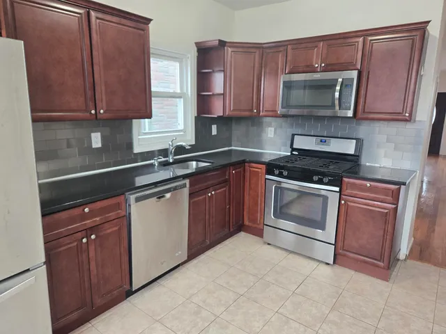 a kitchen with a sink stove and microwave