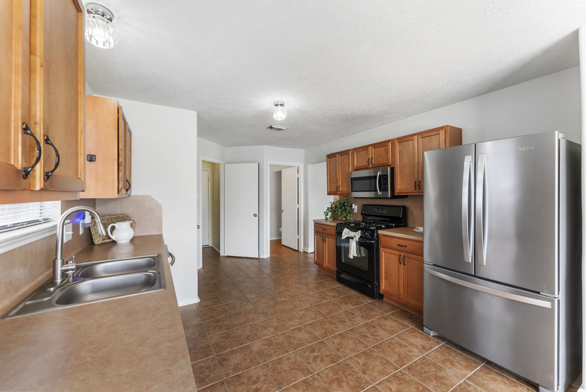 7203 Cool Springs Magnolia, TX 77354 - Photo 10 of 31 a kitchen with stainless steel appliances granite countertop a refrigerator and a sink