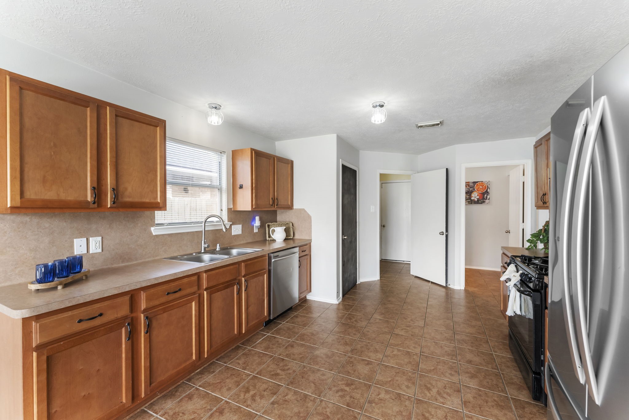 7203 Cool Springs Magnolia, TX 77354 - Photo 11 of 31 a kitchen with stainless steel appliances granite countertop a refrigerator and a sink