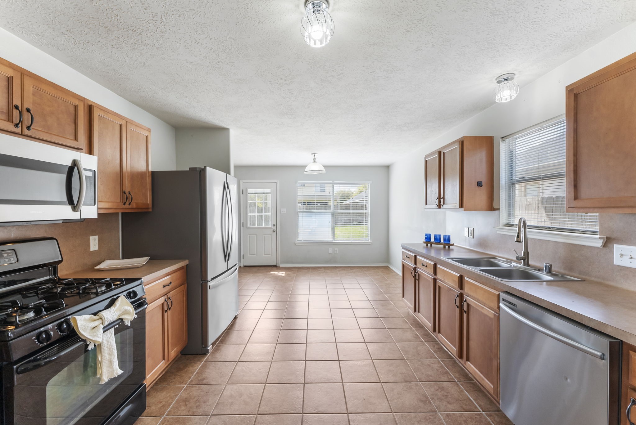7203 Cool Springs Magnolia, TX 77354 - Photo 13 of 31 a kitchen with stainless steel appliances a sink stove and refrigerator